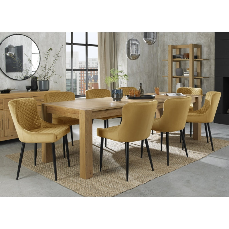 6-10 Seater 185-245cm Extending Light Oak Dining Table with 8 Mustard Velvet Chairs Featuring Black Legs & Diamond Quilted Stitching