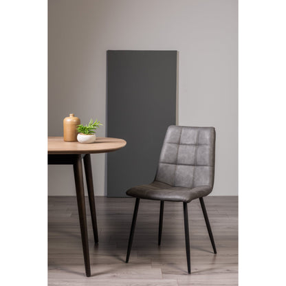 Pair of Dark Grey Faux Leather Dining Chairs with Square Stitched Upholstery and Sand Black Metal Legs