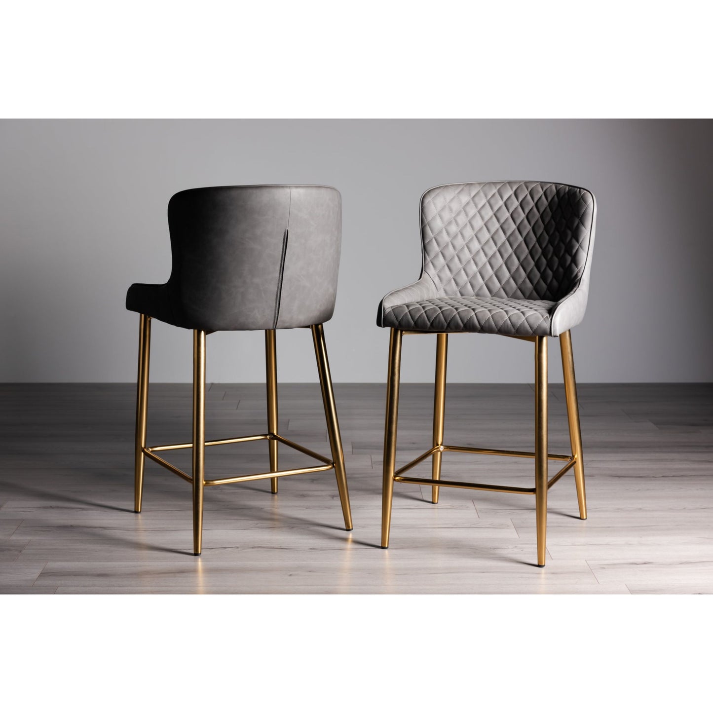 Pair of Dark Grey Faux Leather Bar Stools with Diamond Stitched Upholstery and Matt Gold Metal Legs