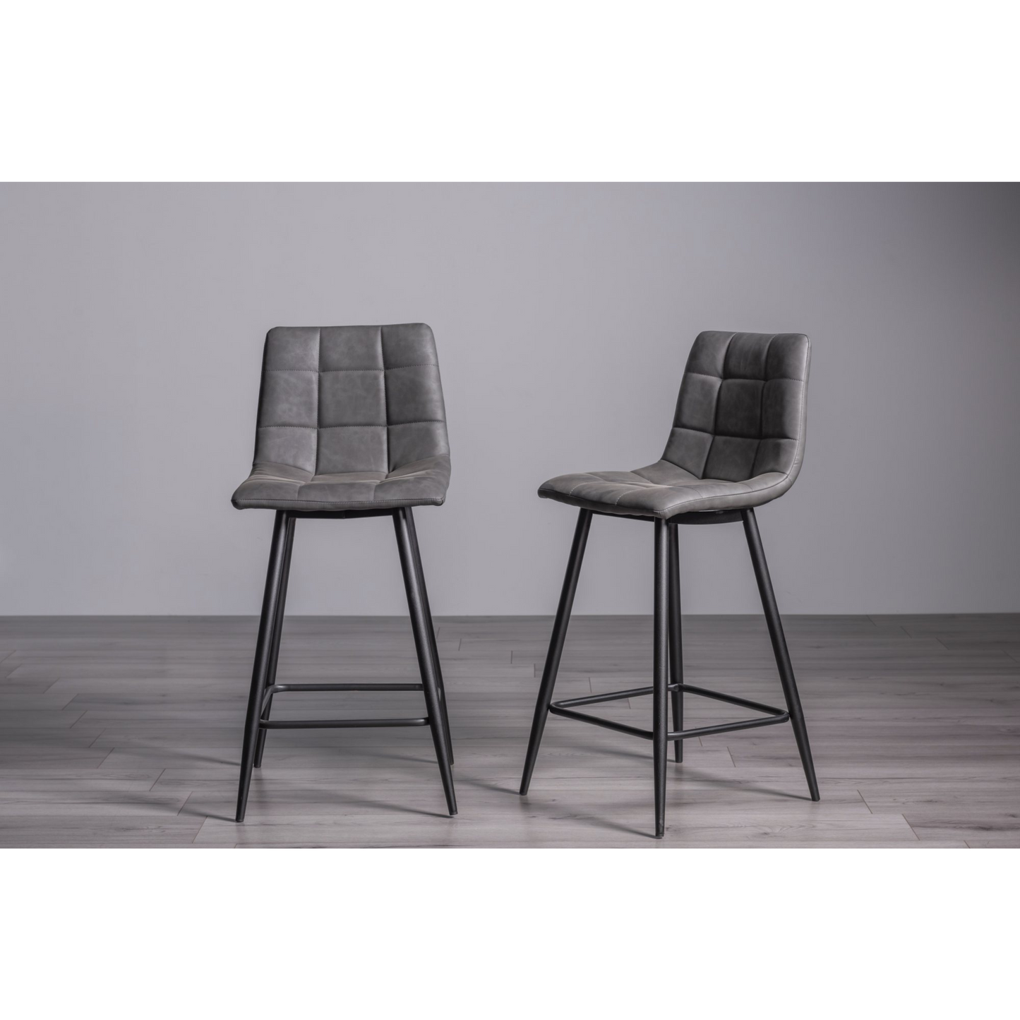 Pair of Dark Grey Faux Leather Bar Stools with Square Stitched Upholstery and Sand Black Powder Coated Legs